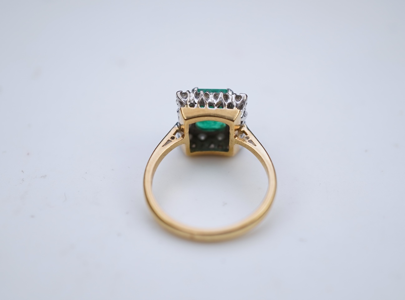 An emerald and diamond ring